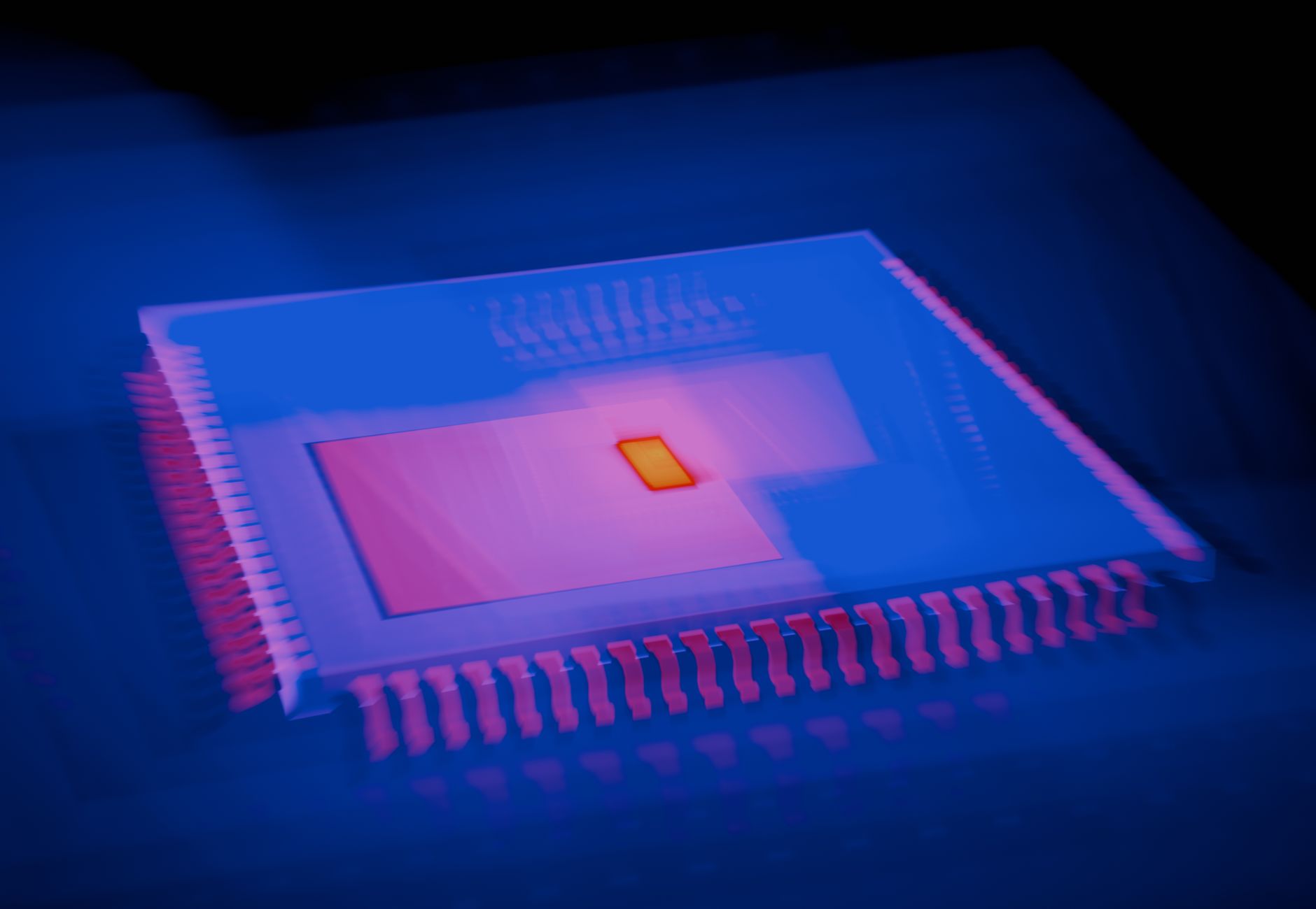 Blurred abstract image of a microchip with heatmap colors highlighting technological innovation.